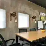 Applique murale LED rétro avec poulie en bronze dans un intérieur industriel