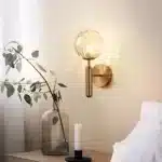 Applique murale dorée avec globe lumineux effet bulle pour chambre.
