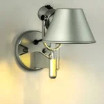 Applique murale LED argentée installée dans une chambre à coucher, offrant un éclairage doux et efficace.