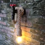 Applique murale en corde de chanvre, vue de dessus, montrant la fixation murale et la corde enroulée.