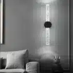 Applique murale LED noire montée sur un mur gris.