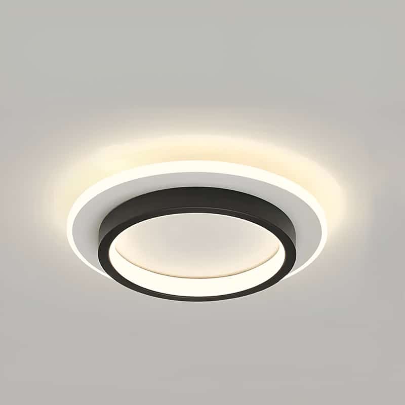 Plafonnier LED moderne rond noir avec une base blanche.